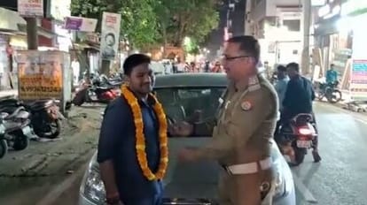 Action in unique way challan of Rs 2500  to car driver wearing garland in varanasi