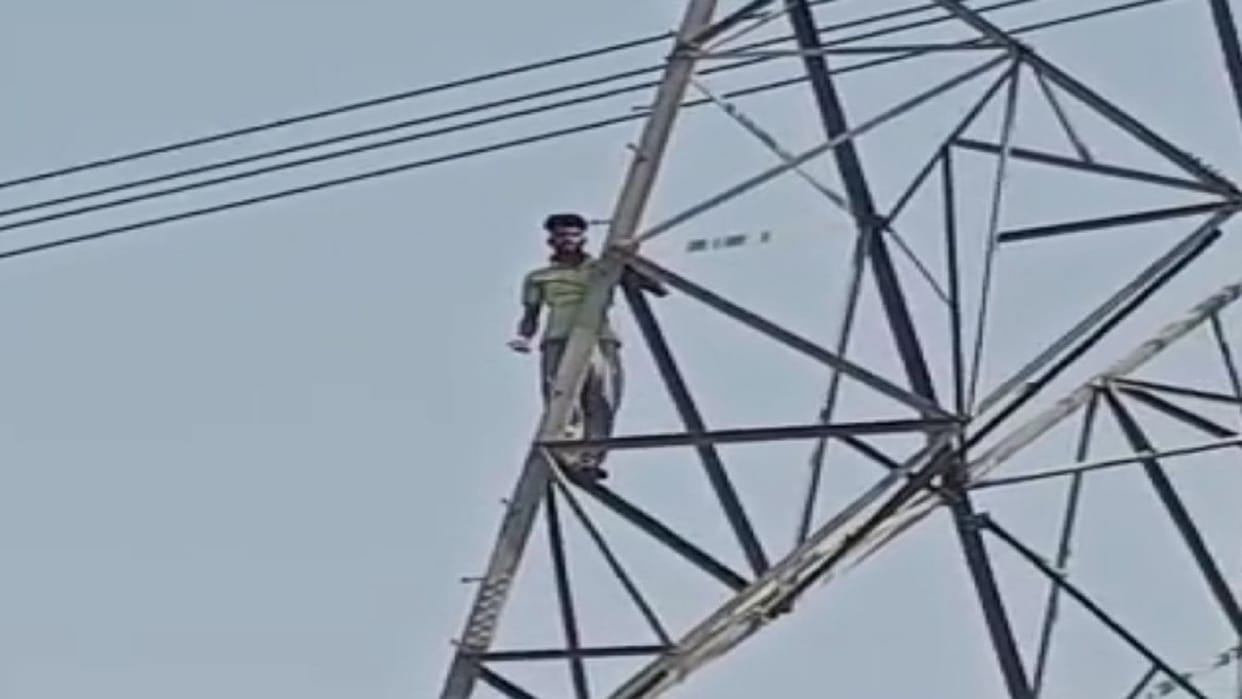Youth creates ruckus by climbing on the tower of high tension line
