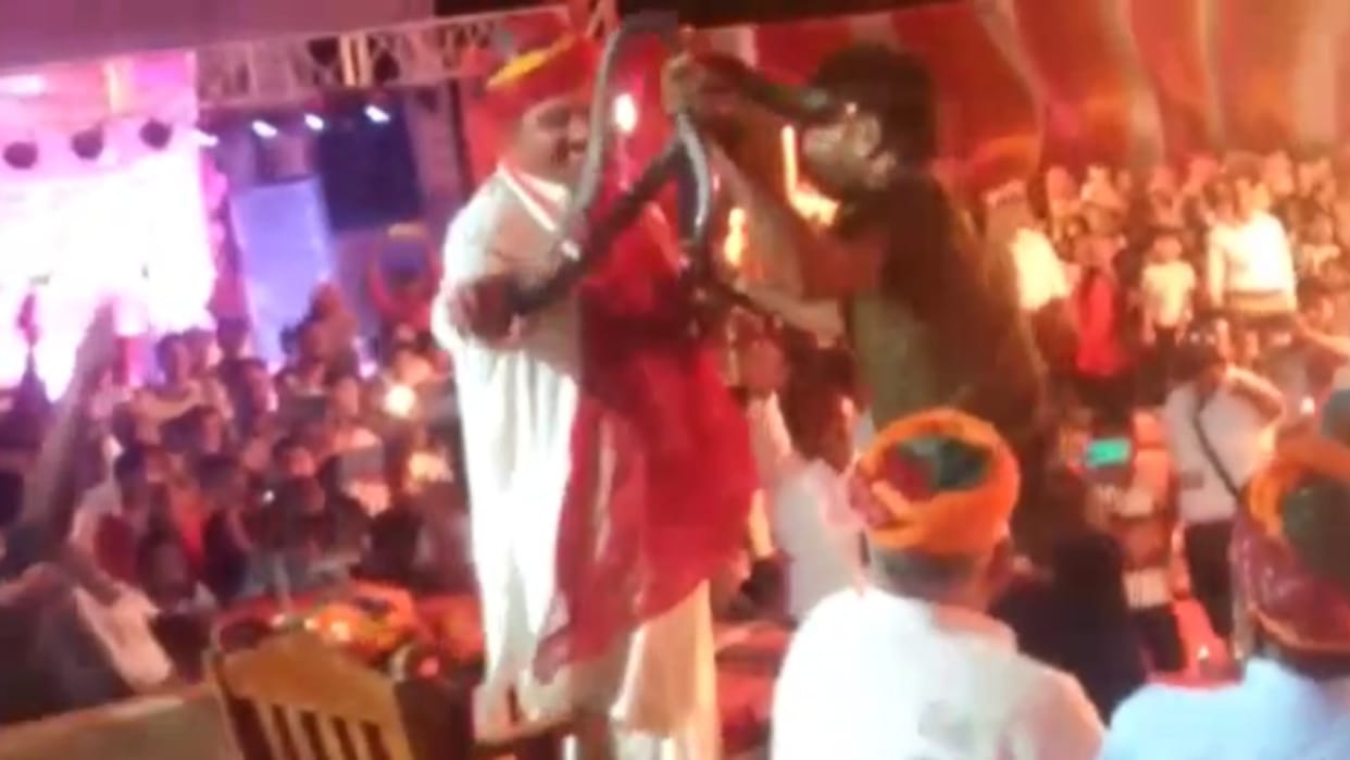 Snake charmer put two cobra snakes around cabinet minister Saleh Mohammad's neck in Jaisalmer