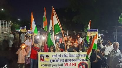Residents take out candle march against liquor shop with tricolor in their hands