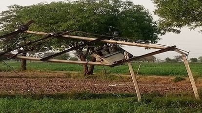 Electric pole broken by strong storm hanging transformer