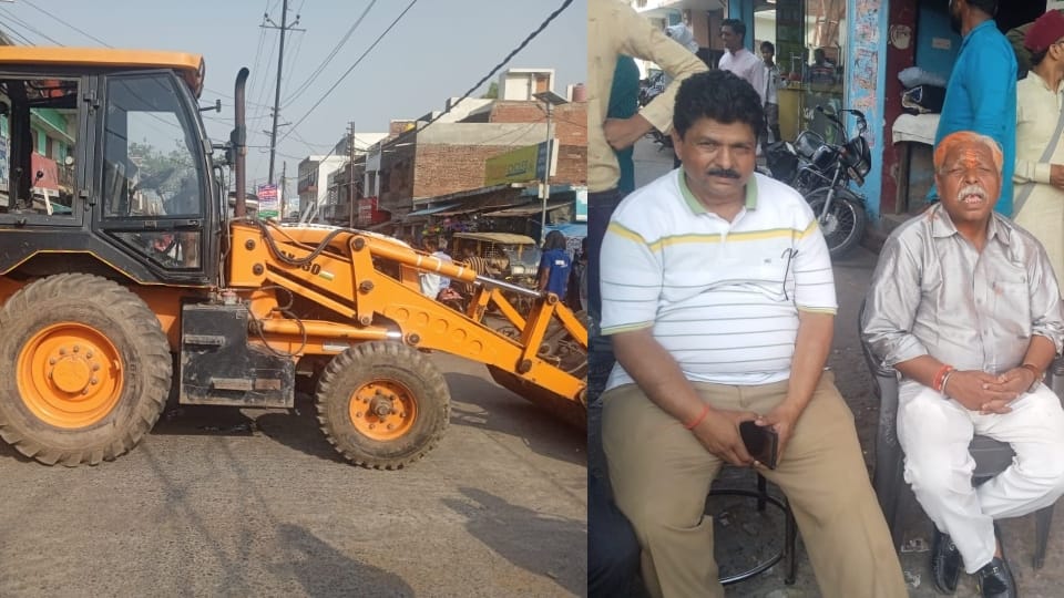 former chairman sons sitting in front of bulldozer in Pilibhit
