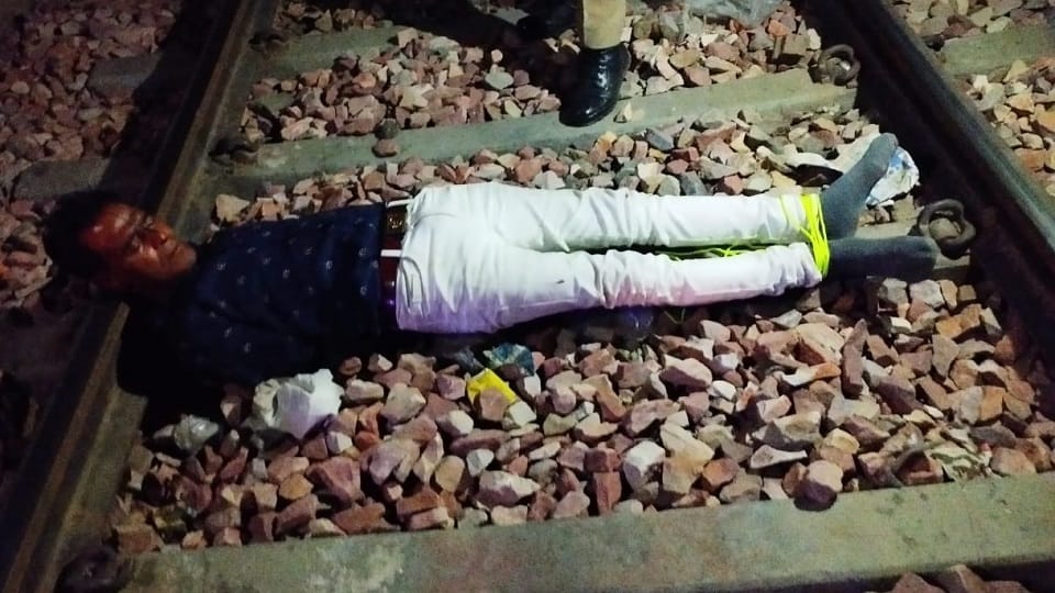 Tied hands and legs threw the young man on the railway line