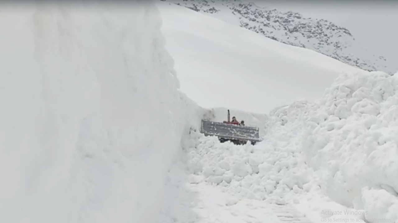 Rohtang Pass being restored by cutting 12 feet high walls of ice in minus temperature, see photos