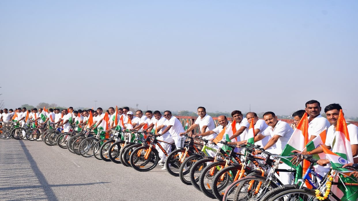 Message of yoga given through cycle rally, yoga practice done on the banks of the Ganges