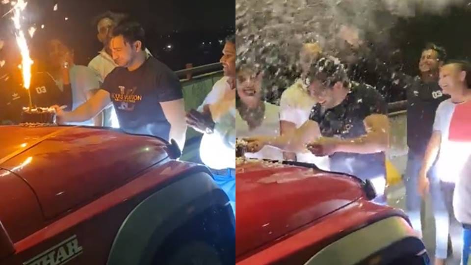 Cut cake and fireworks by placing it on the bonnet of the car on the elevated road