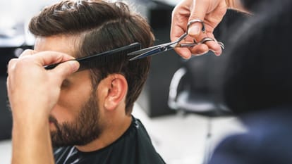 boy pays bill for hair cutting in salon money by taking loan