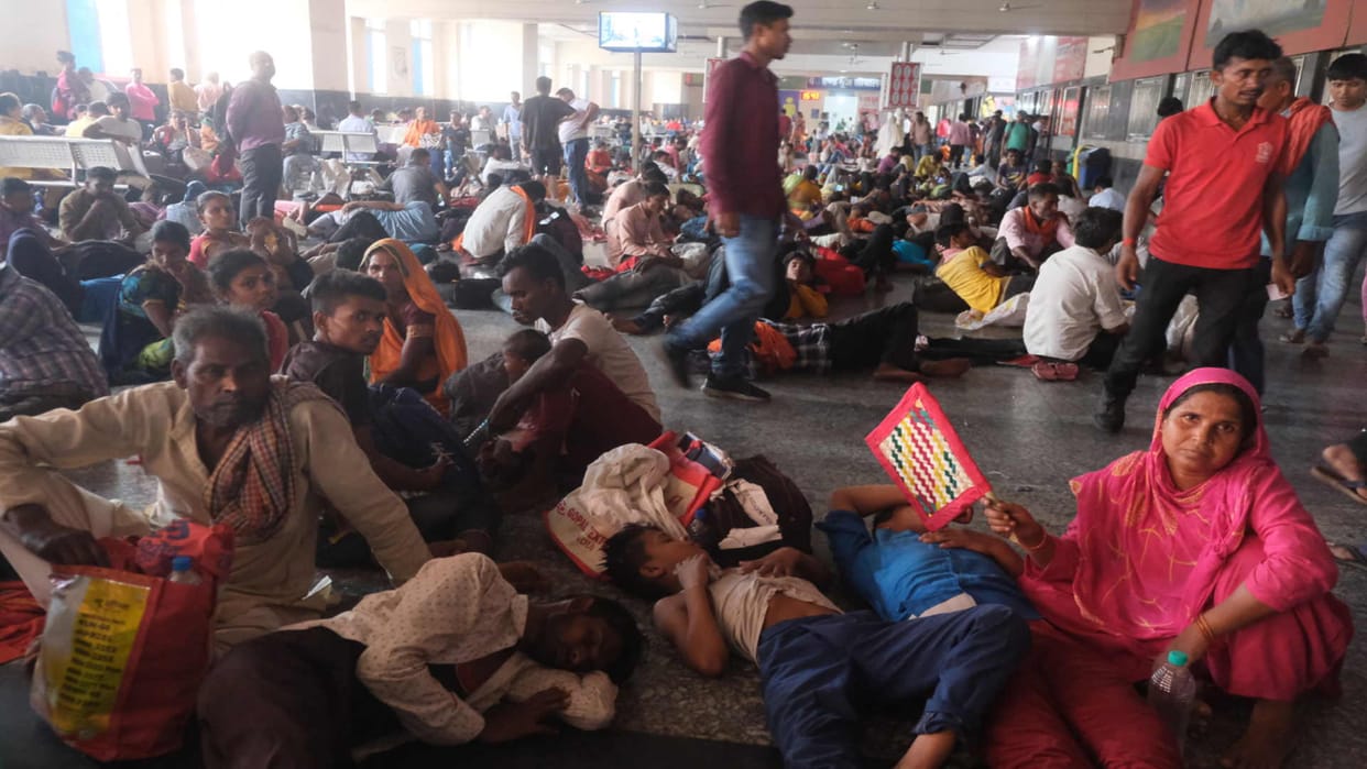 People getting restless waiting for trains at railway station