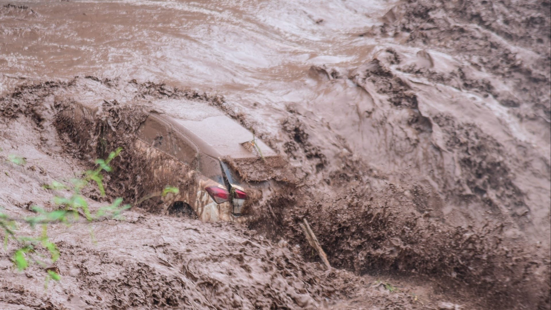 Woman washed away along with car in Ghaggar river, seven youths saved, see photos