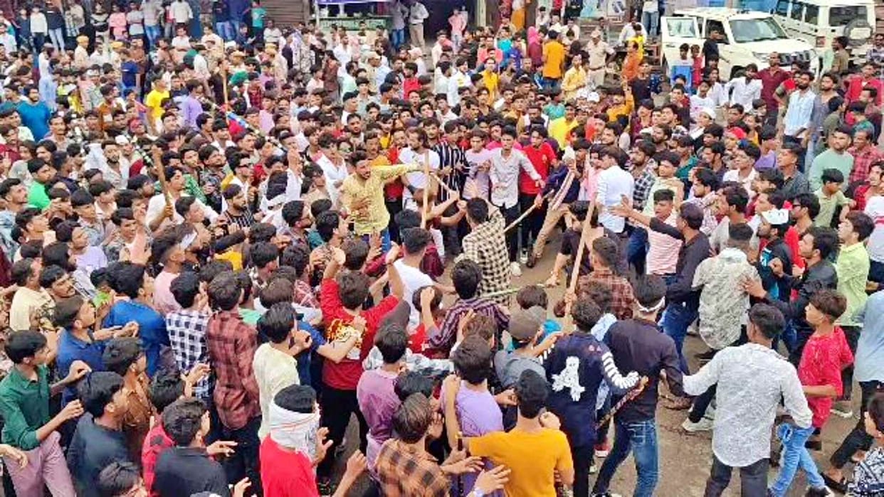 Youth showing stunts during Tajiya procession on Muharram in Sikar