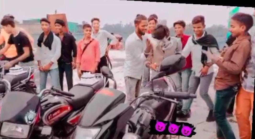 Bike parked on the middle of the road and cut the cake with a sword