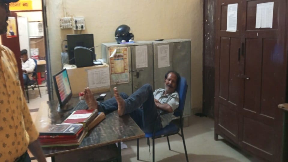 employee in office resting with feet on desk
