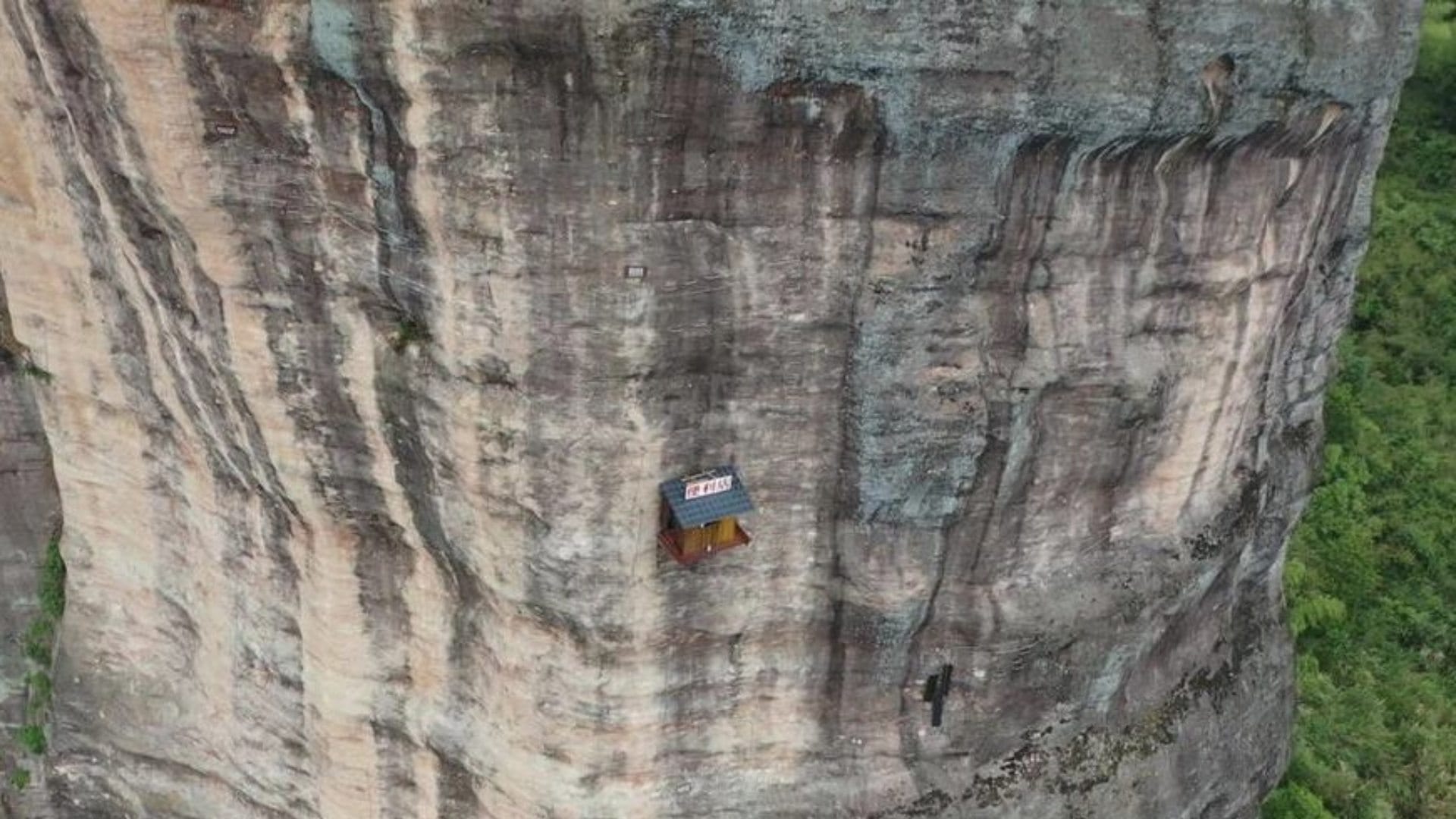 weird shop china located at 393 feet on the side of a cliff customers go on rope to have