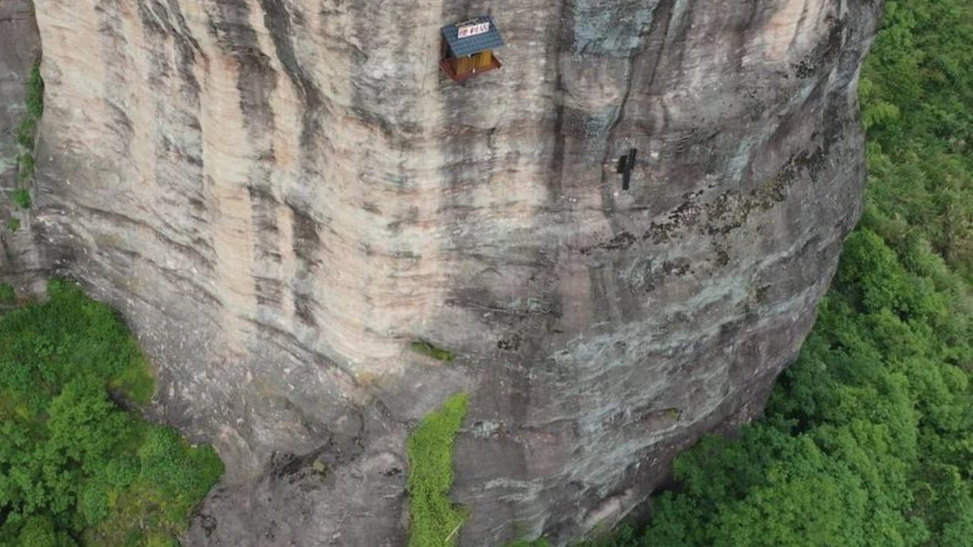 weird shop china located at 393 feet on the side of a cliff customers go on rope to have