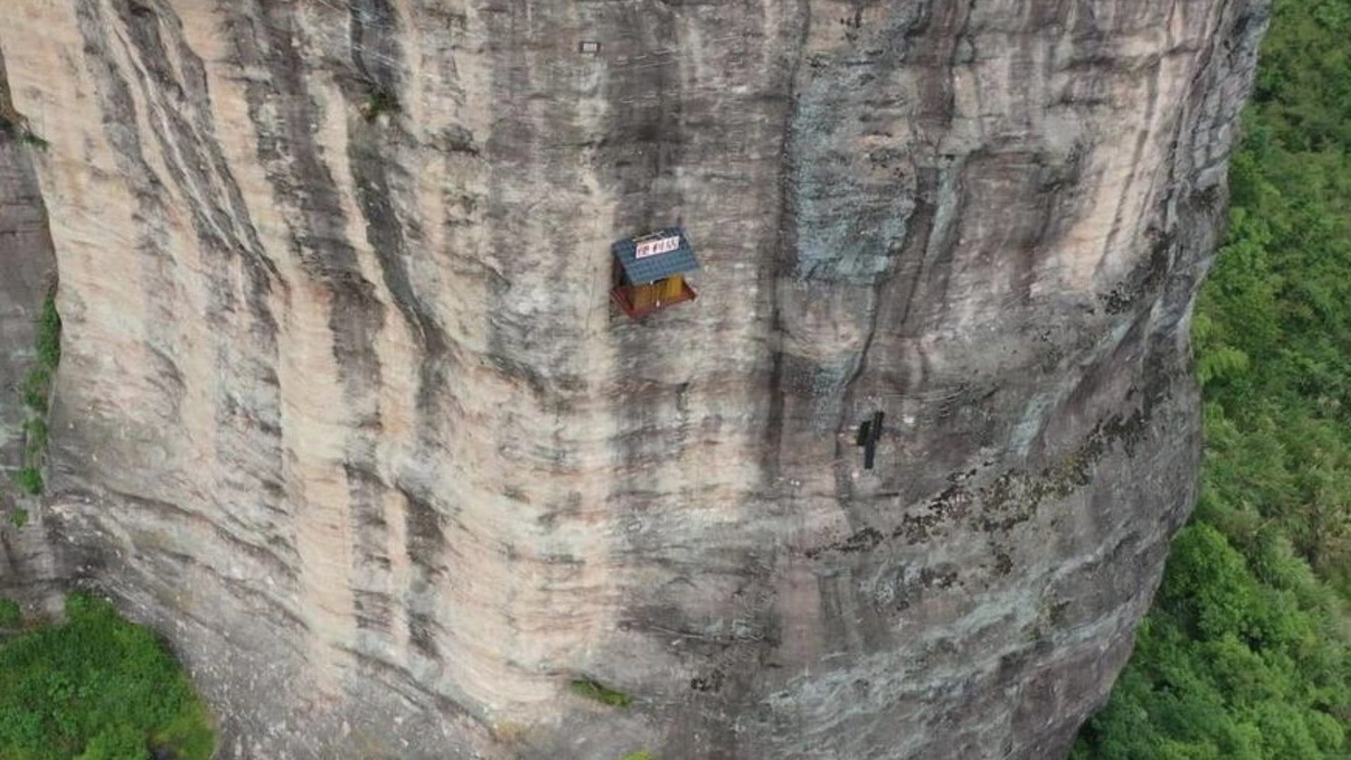weird shop china located at 393 feet on the side of a cliff customers go on rope to have