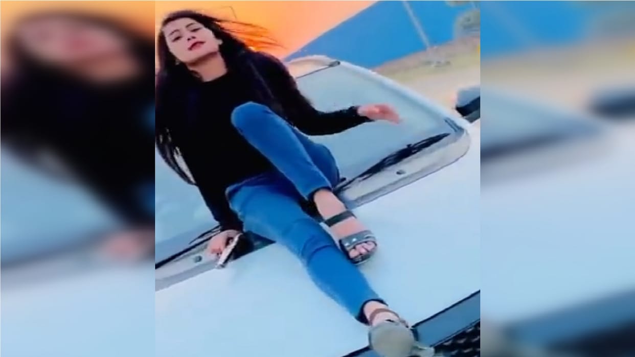 Pictures of girl doing stunt with pistol on car bonnet in Noida go viral