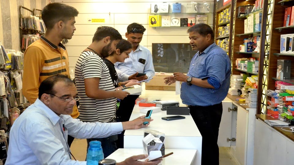 Brother buying smart phone, watch, tablet for sister