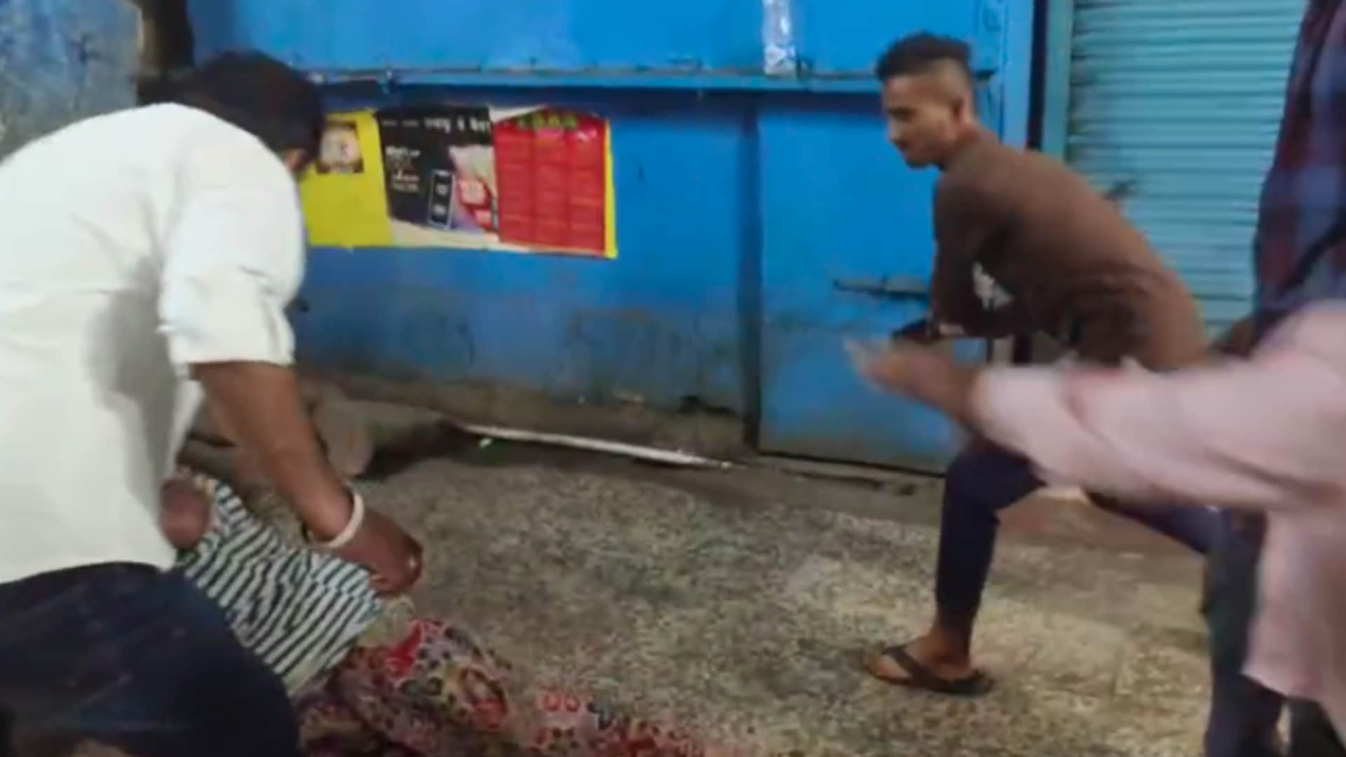mad woman was brutally beaten, someone was dragging her and someone was beating her with sticks and kicks.