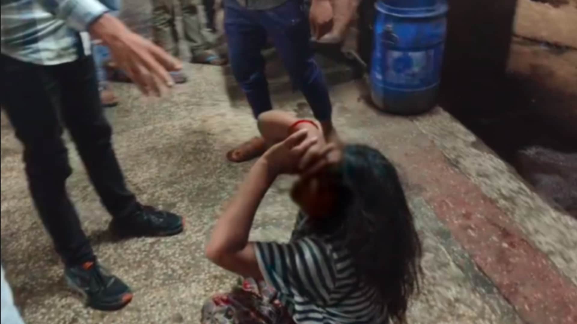 mad woman was brutally beaten, someone was dragging her and someone was beating her with sticks and kicks.