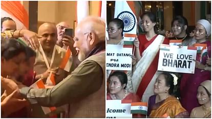 Members of Indian Diaspora greet and shake hands with PM Modi as he arrives at hotel in Jakarta