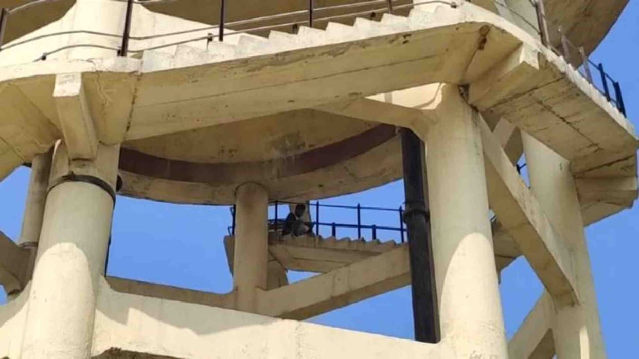 A young man climbed on a water tank carrying a petrol bottle in Bharatpur