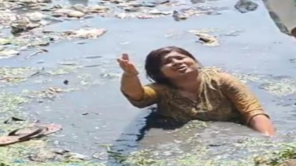 Woman standing in a dirty drain