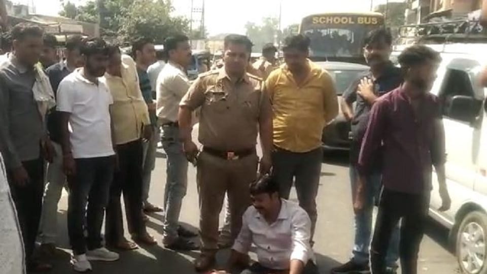 Dead body of innocent son and crying father on the road