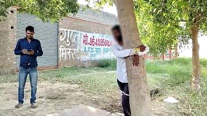 young man was tied to tree and beaten severely for stealing sack of grain In Agra