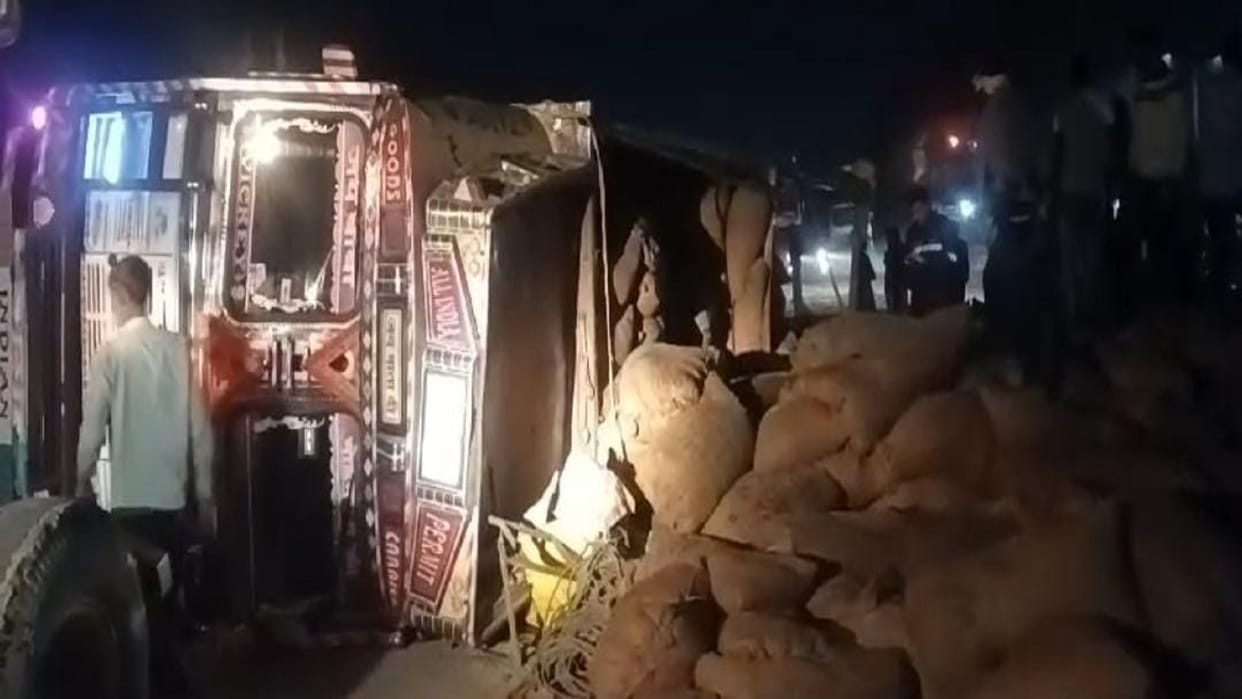road accident in Hapur Overloaded paddy truck overturns on highway