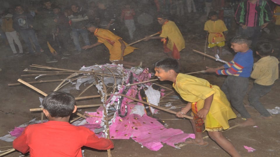 The cowherd boy killed Kansa by beating him with sticks