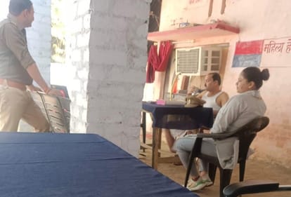 The police station in charge, wearing a angochha-baniyaan was sitting at the police stations female desk