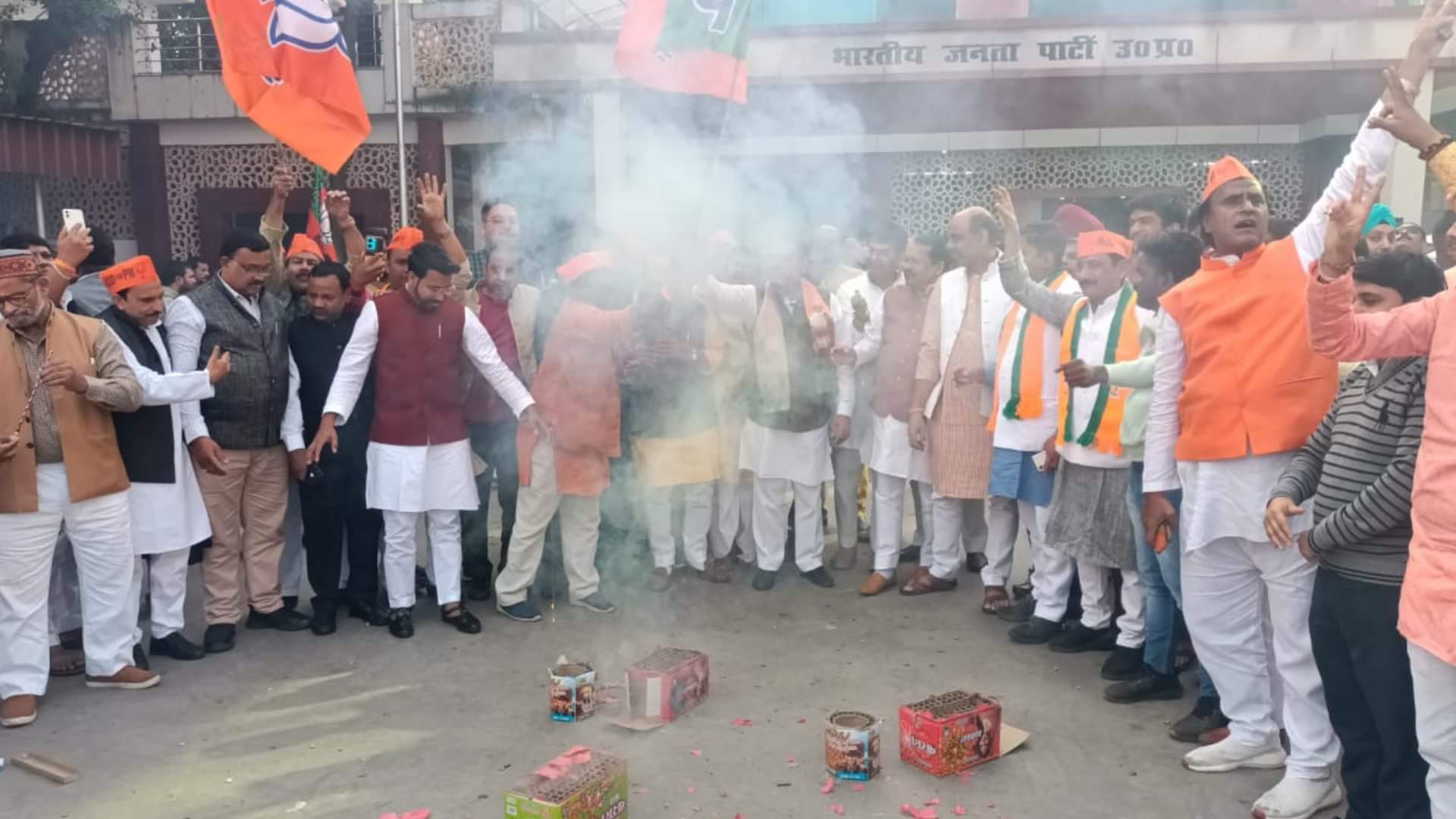 BJP activists celebrate victory in three states in party head quarter in Lucknow.