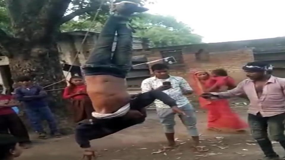 In Mirzapur, a young man was hanged upside down on a tree and beaten.