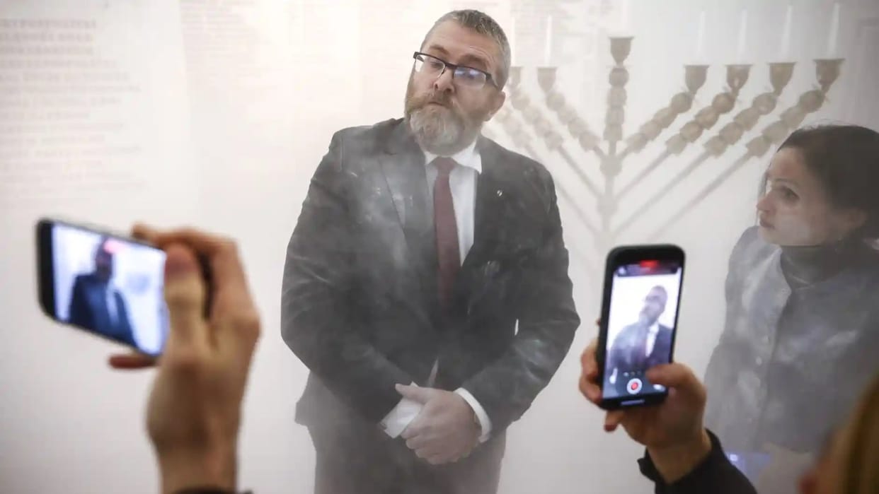 Poland lawmaker Grzegorz Braun extinguishes Hanukkah candles in Parliament