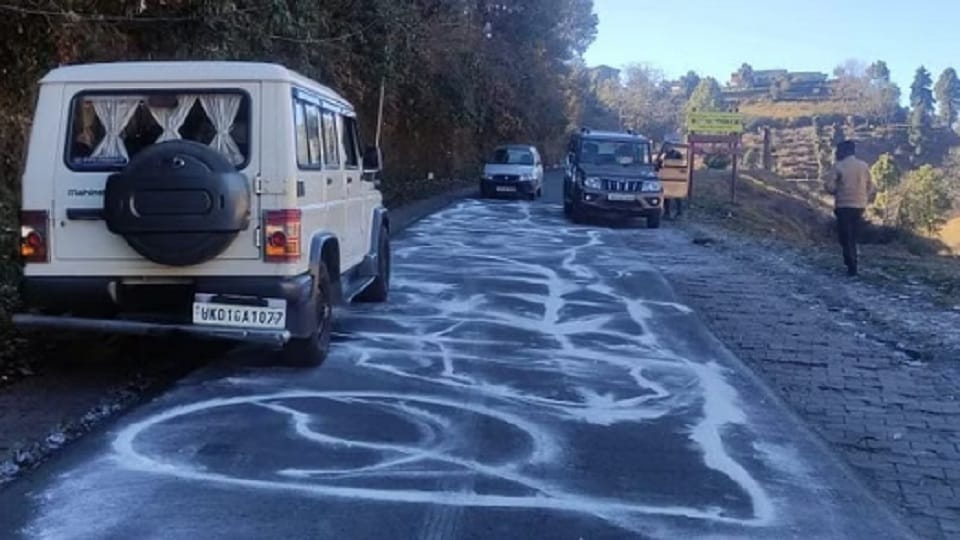Spraying of salt on frost on roads in winter in almora