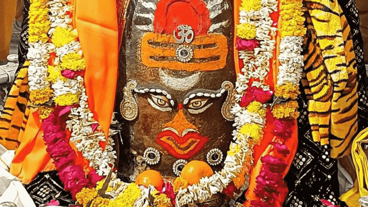 Baba Mahakal decorated with different flowers, Surya and Tripund adornment on his head