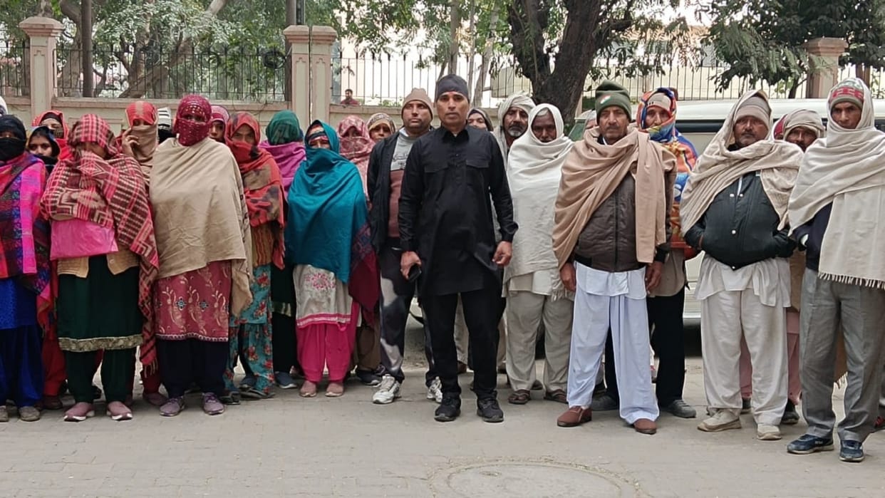 District councilor wearing black clothes demonstrated with villagers to get possession of plots in Sonipat