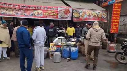 फायरिंग के बाद दुकान पर पहुंची पुलिस और जुटी लोगों की भीड़।