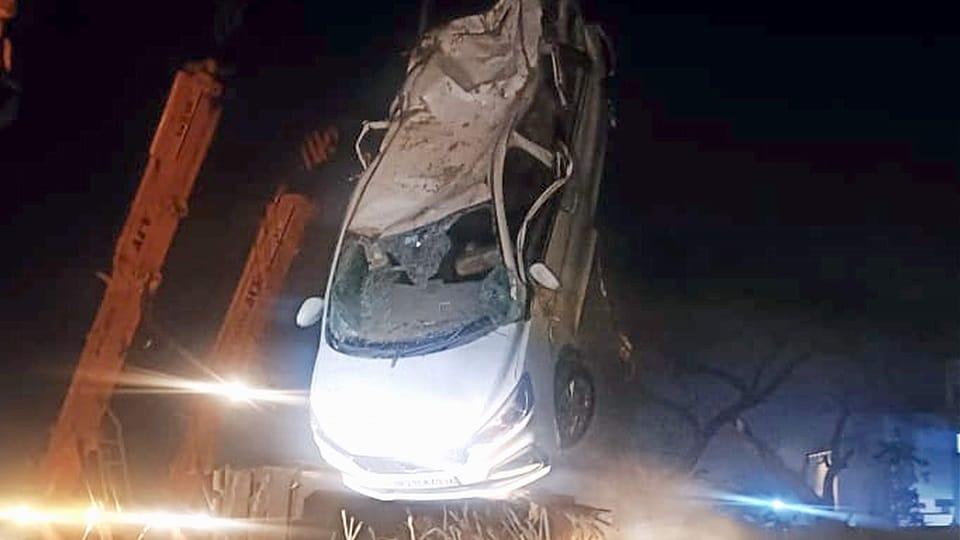 Overloaded truck laden with sugarcane overturned on car, seven people got injured after being crushed