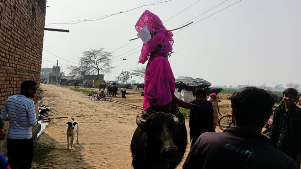 effigy of BJP MLA was taken around the village by placing it on a buffalo