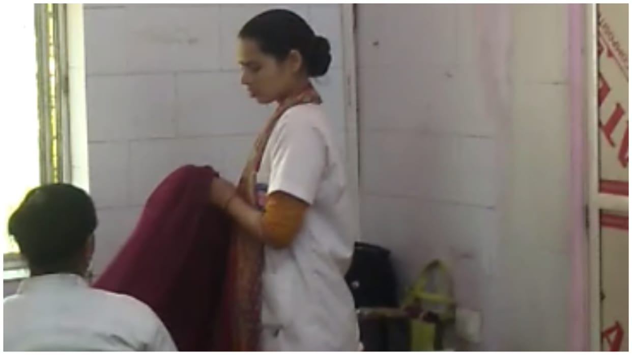 Patients stood in line in pathology lab of Rajgarh district hospital female staff looking at sarees purchased