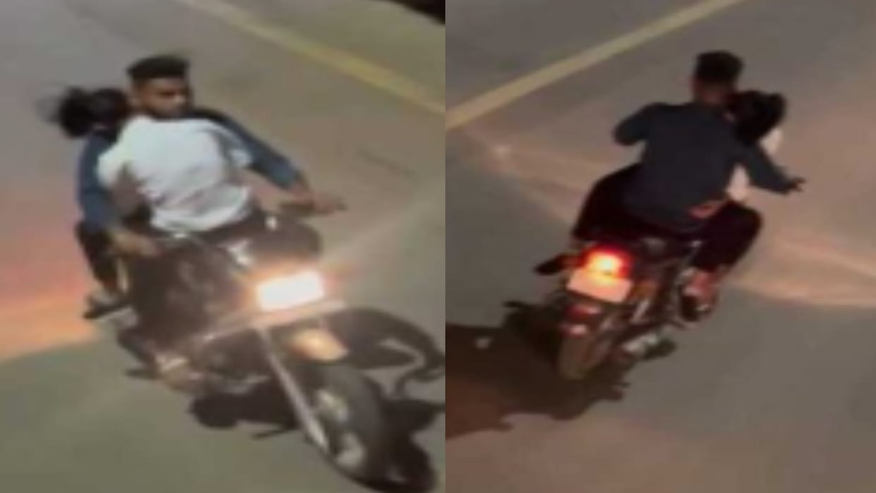 CG: Lovers seen romancing on a moving bike; young man was riding a bike with a girl sitting on tank of bike, V