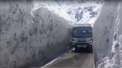 HRTC bus passes through several feet high walls of snow on Kullu-Keylong road