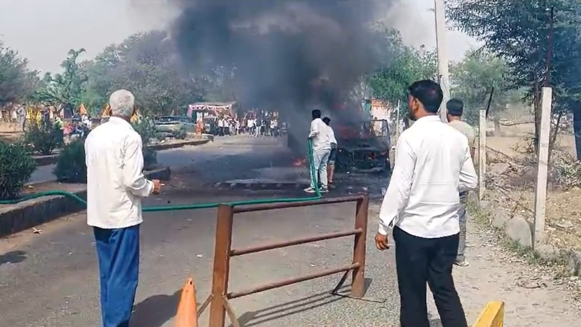 सड़क पर जलती हुई स्कॉर्पियो गाड़ी