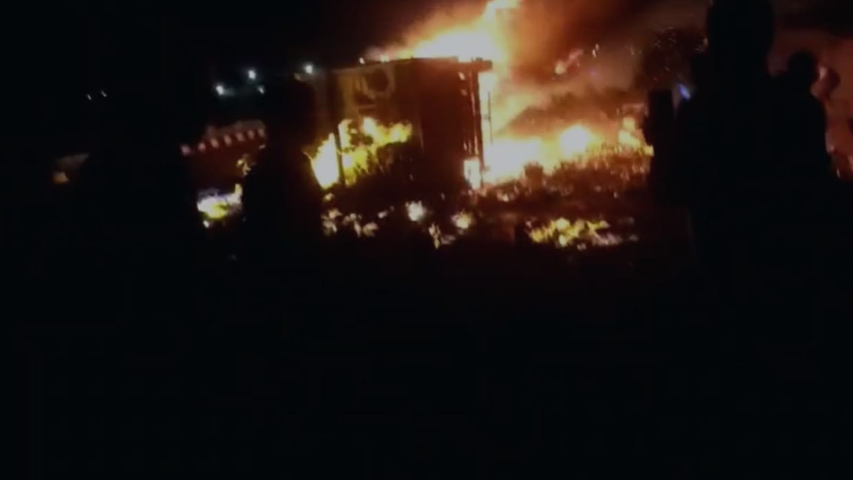 Pickup vehicle loaded with liquor caught fire after overturning