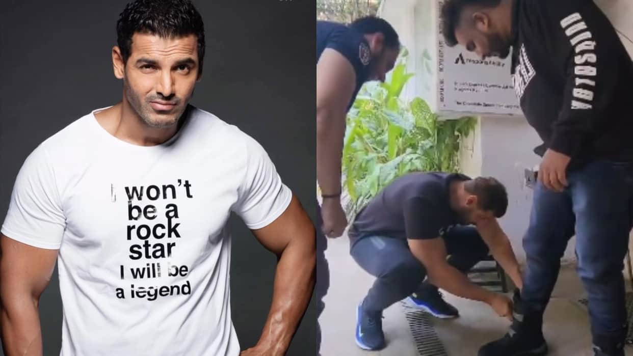 John Abraham was seen helping fan wear the shoes by bending down and fastening the straps with his own hands