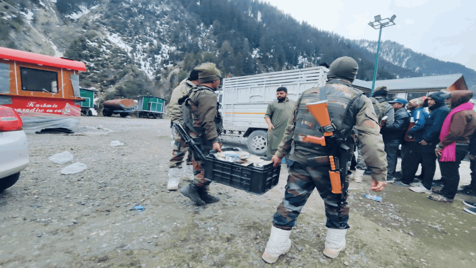 Indian Army soldiers distributes relief material food packet among passengers
