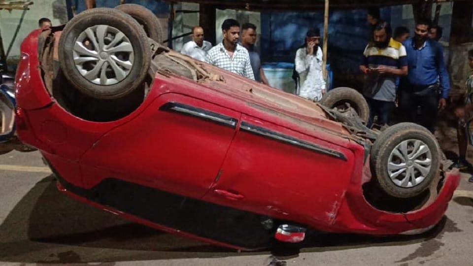 Speeding car overturns after hitting divider
