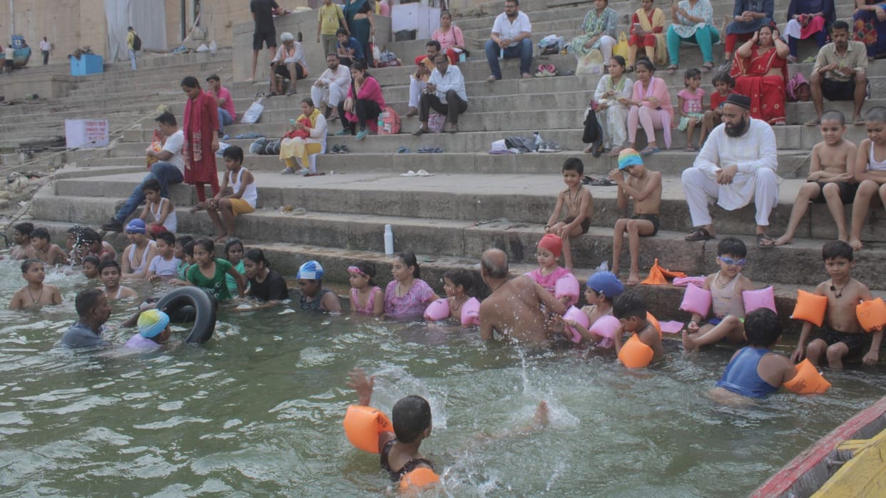 many players learning swimming Ganga river in varanasi