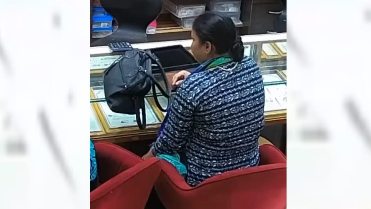A woman steels tops from goldsmiths shop in Lucknow.